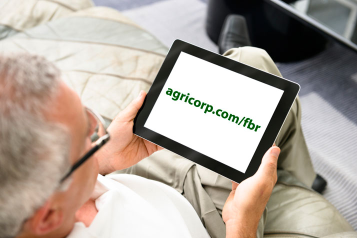 Man viewing tablet screen showing agricorp.com/fbr